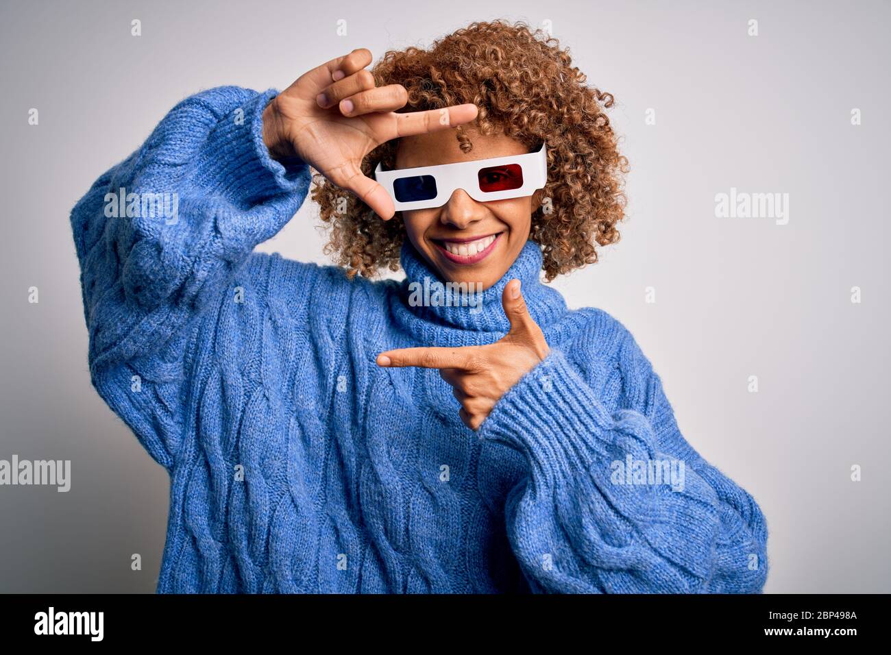 Young african american curly woman wearing 3d glasses over isolated ...