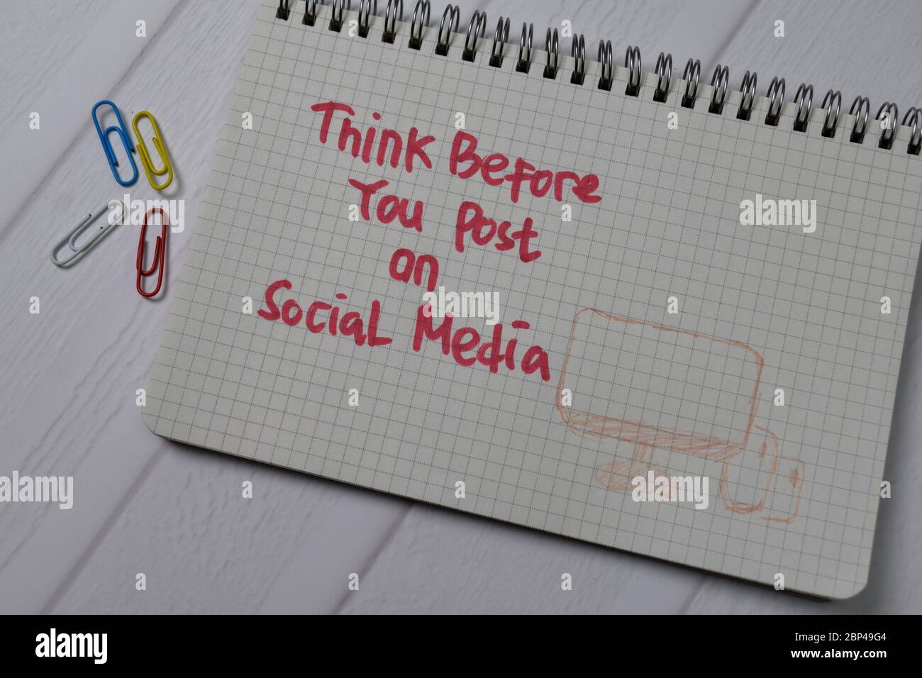 Think Before You Post On Social Media write on a book isolated on wooden table. Stock Photo
