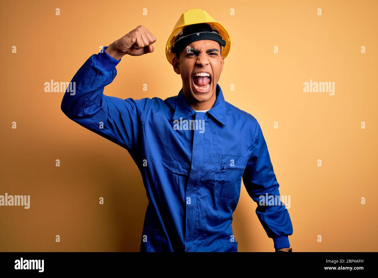 Young handsome african american worker man wearing blue uniform and ...