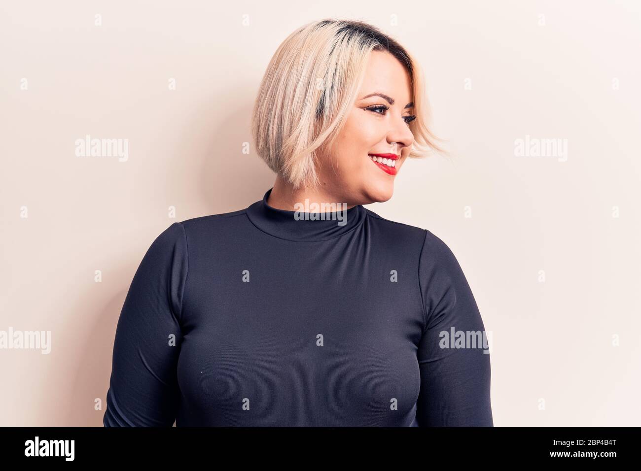 Young beautiful blonde plus size woman wearing casual sweater over isolated  white background looking to side, relax profile pose with natural face and  Stock Photo - Alamy