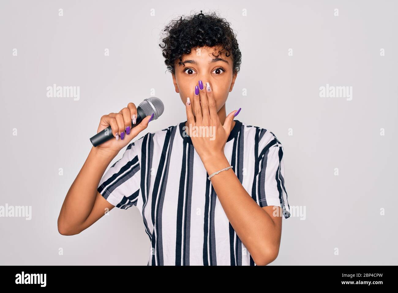 Beautiful african american afro singer woman singing using microphone