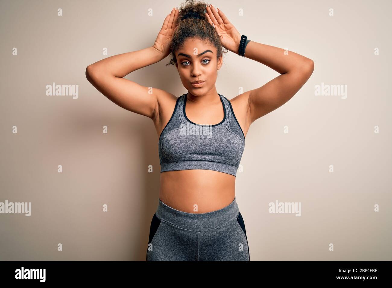 Young african american sportswoman doing sport wearing sportswear over  white background Doing bunny ears gesture with hands palms looking cynical  and Stock Photo - Alamy