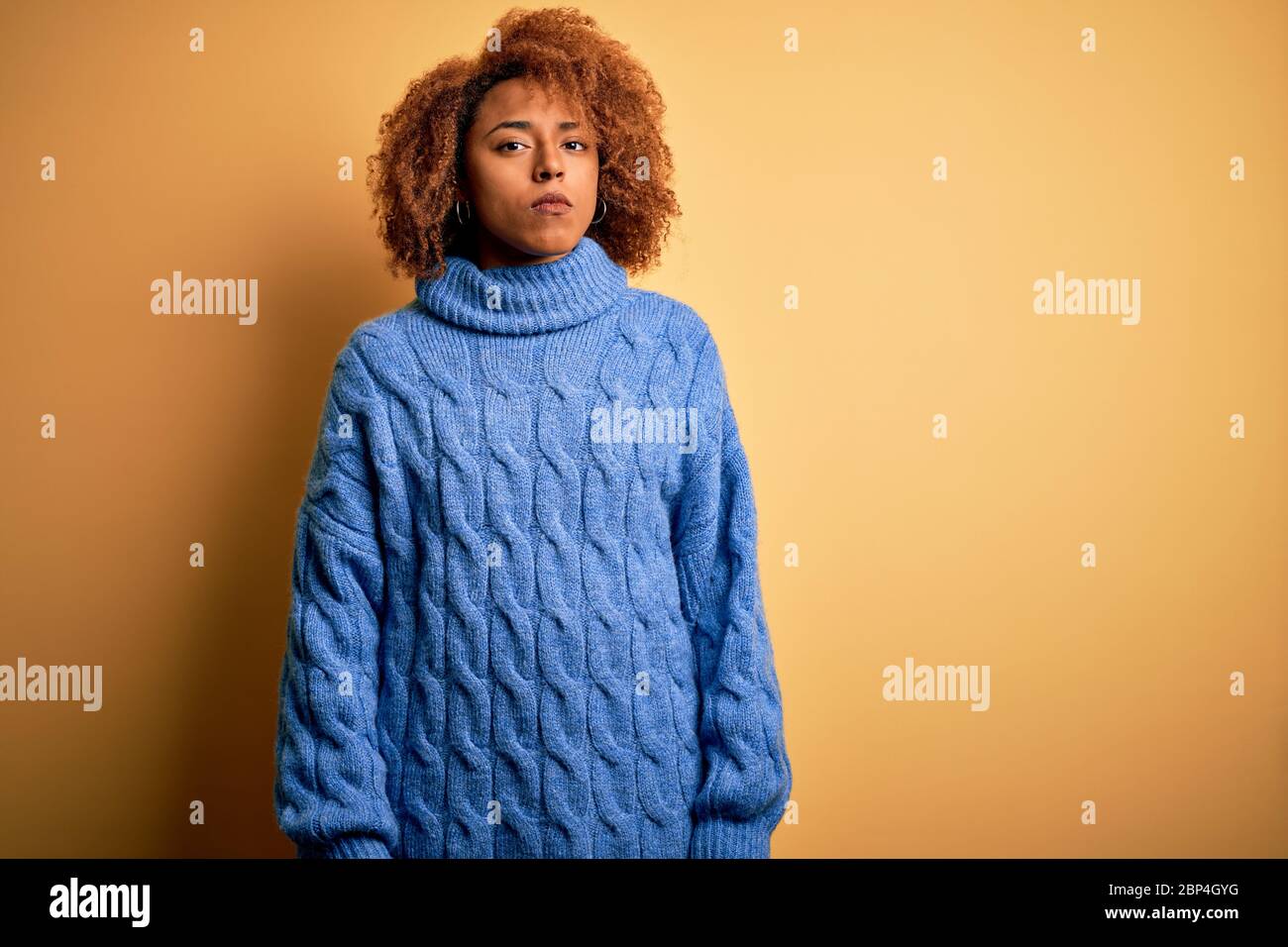 Young beautiful African American afro woman with curly hair wearing ...
