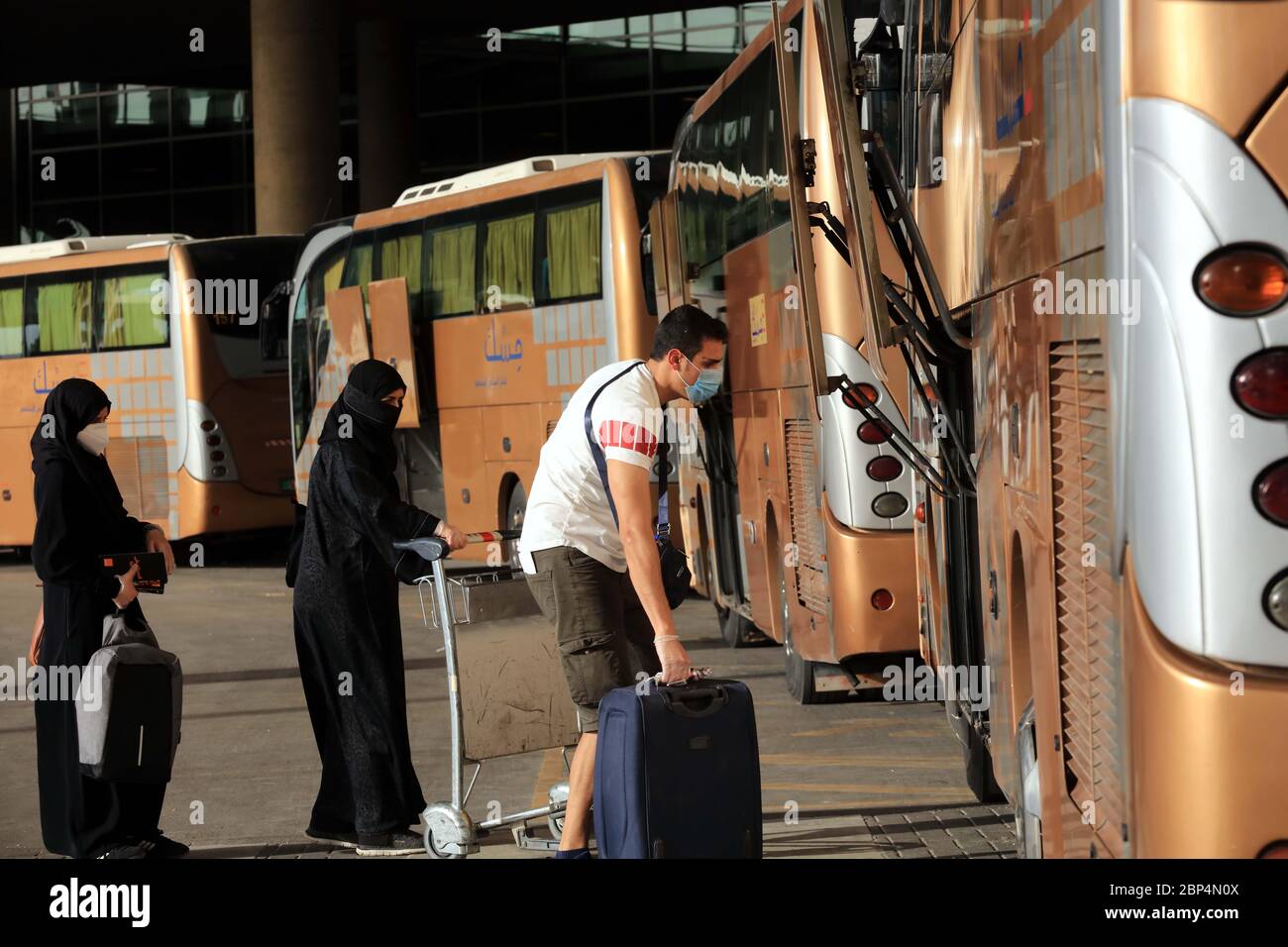 Amman, Jordan. 17th May, 2020. Jordanians coming from abroad prepare to get  on a bus at the Queen Alia International Airport in Amman, Jordan, on May  17, 2020. Jordan's Health Minister Saad