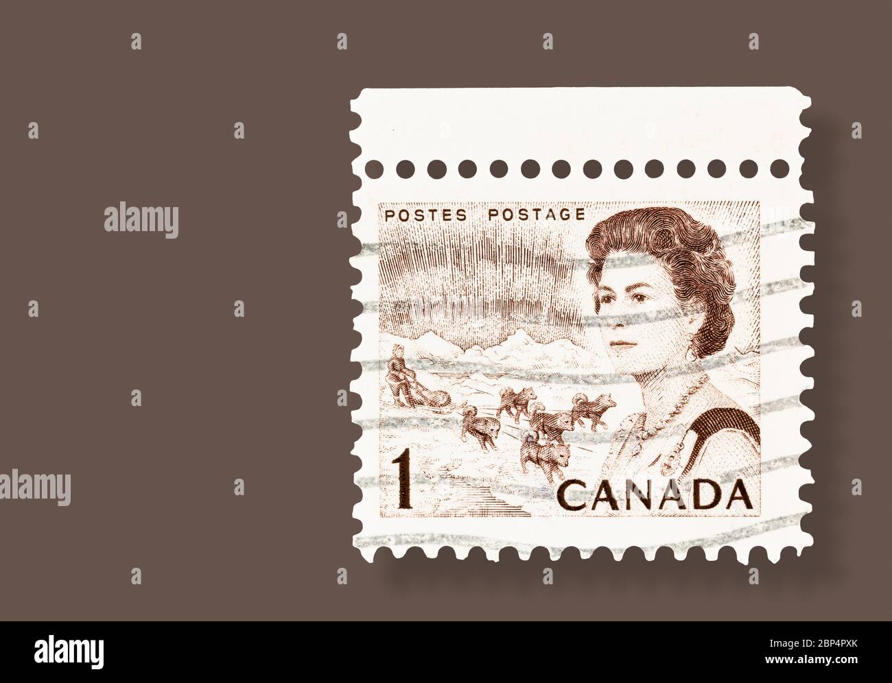 SEATTLE WASHINGTON - May 16, 2020: 1967 Queen Elizabeth defnitive stamp featuring dogs and sled and the Northern Lights on brown background with drop Stock Photo
