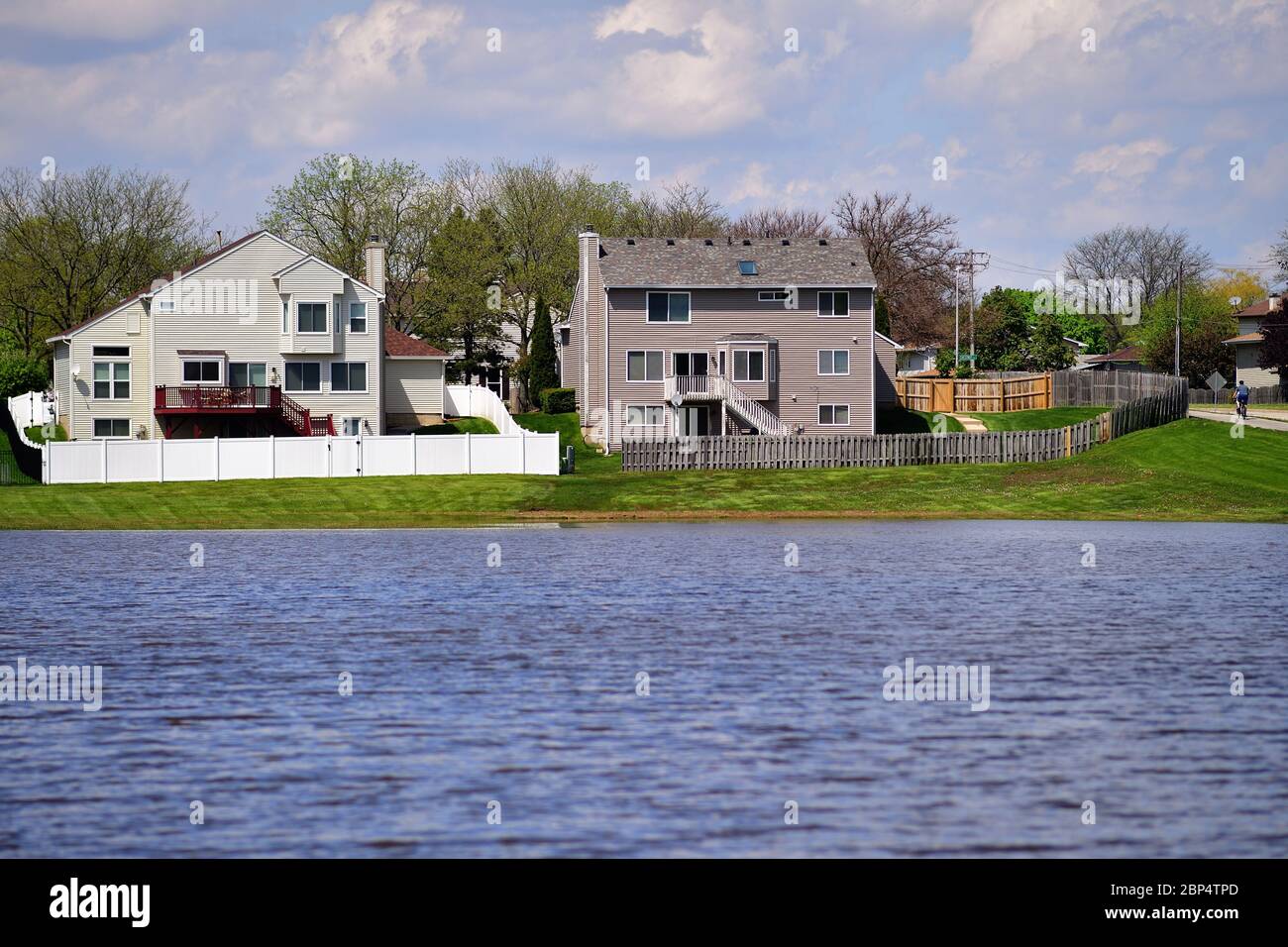 Carol Stream, Illinois, USA. Heavy rains from the night before fill a retention pond an encroach on residential backyards. Stock Photo