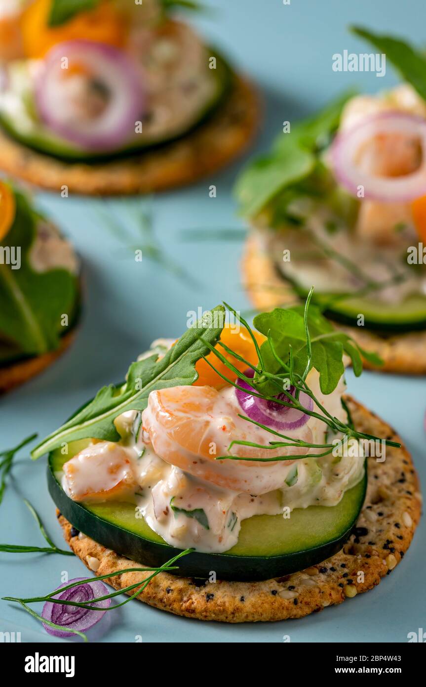 Shrimp salad on whole grains crackers on party serving platter Stock