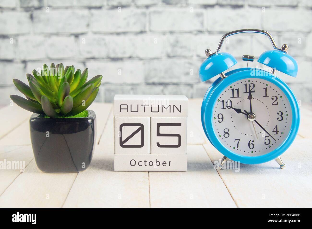 October 5 on the wooden calendar.The fifth day of the autumn month, a calendar for the workplace. Autumn Stock Photo