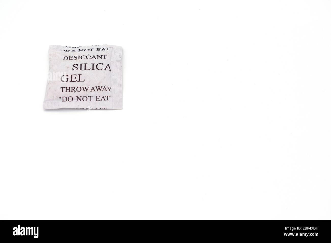 Silica Gel Paper Packet With Do Not Eat Warning White Background Stock Silica Gel Paper Packet With Do Not Eat Warning White Background Stock