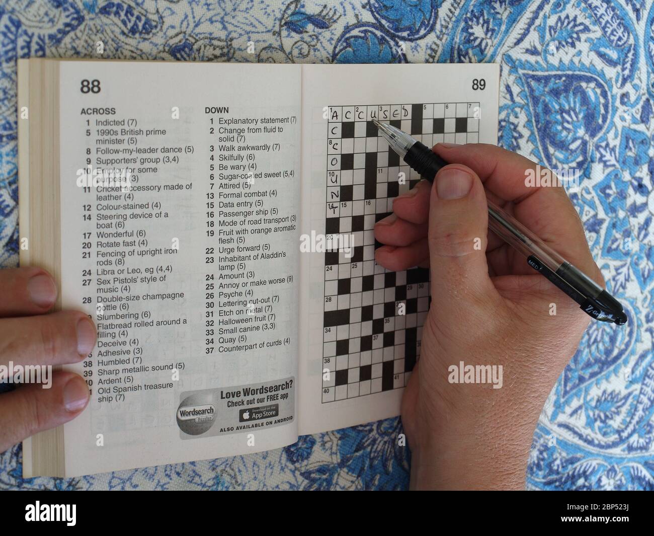 Man Completing A Crossword Puzzle Stock Photo Alamy