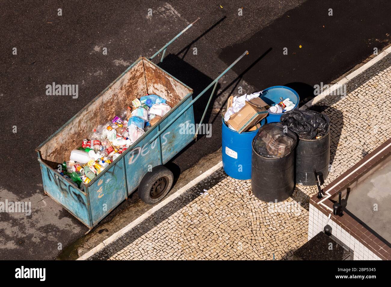 wagon of a waste picker with the word god graffitied Stock Photo