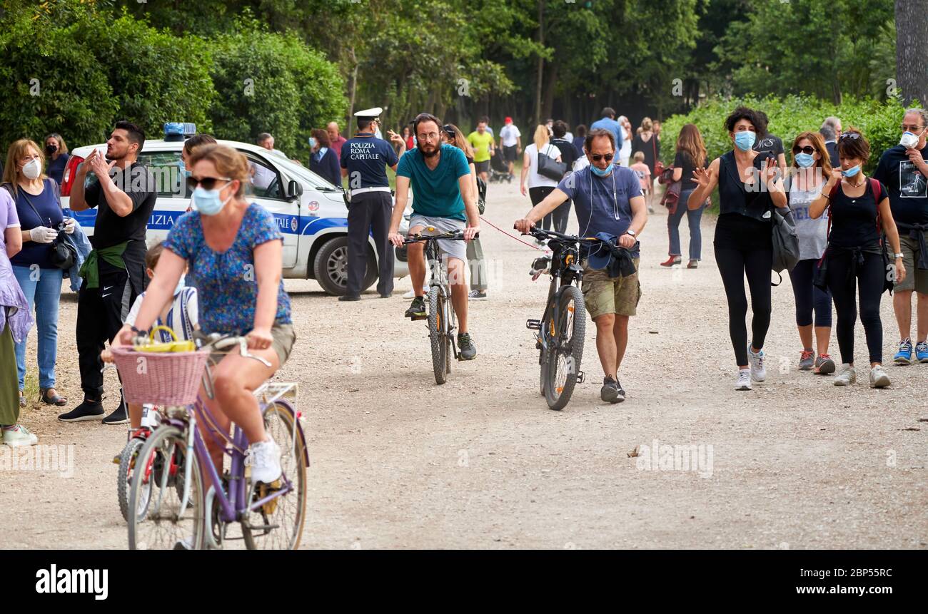 World Bicycle Day: Italian Policemen Watch People Gathering in Rome's Villa Ada Park, Most of Them Wearing Face Masks in Lifted Social Distancing Law Stock Photo