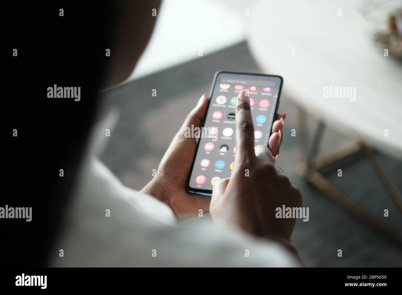 Black Woman Searching Application On Smartphone Stock Photo