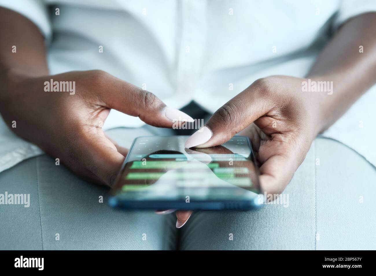 Black Woman Using Mobile Phone For Text Messaging Stock Photo