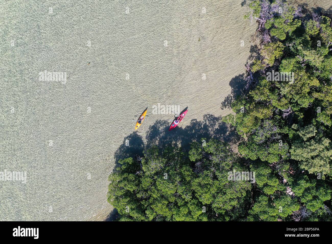 Key Biscayne, Florida May 5, 2020 Young couple enjoys afternoon of kayaking on calm, clear