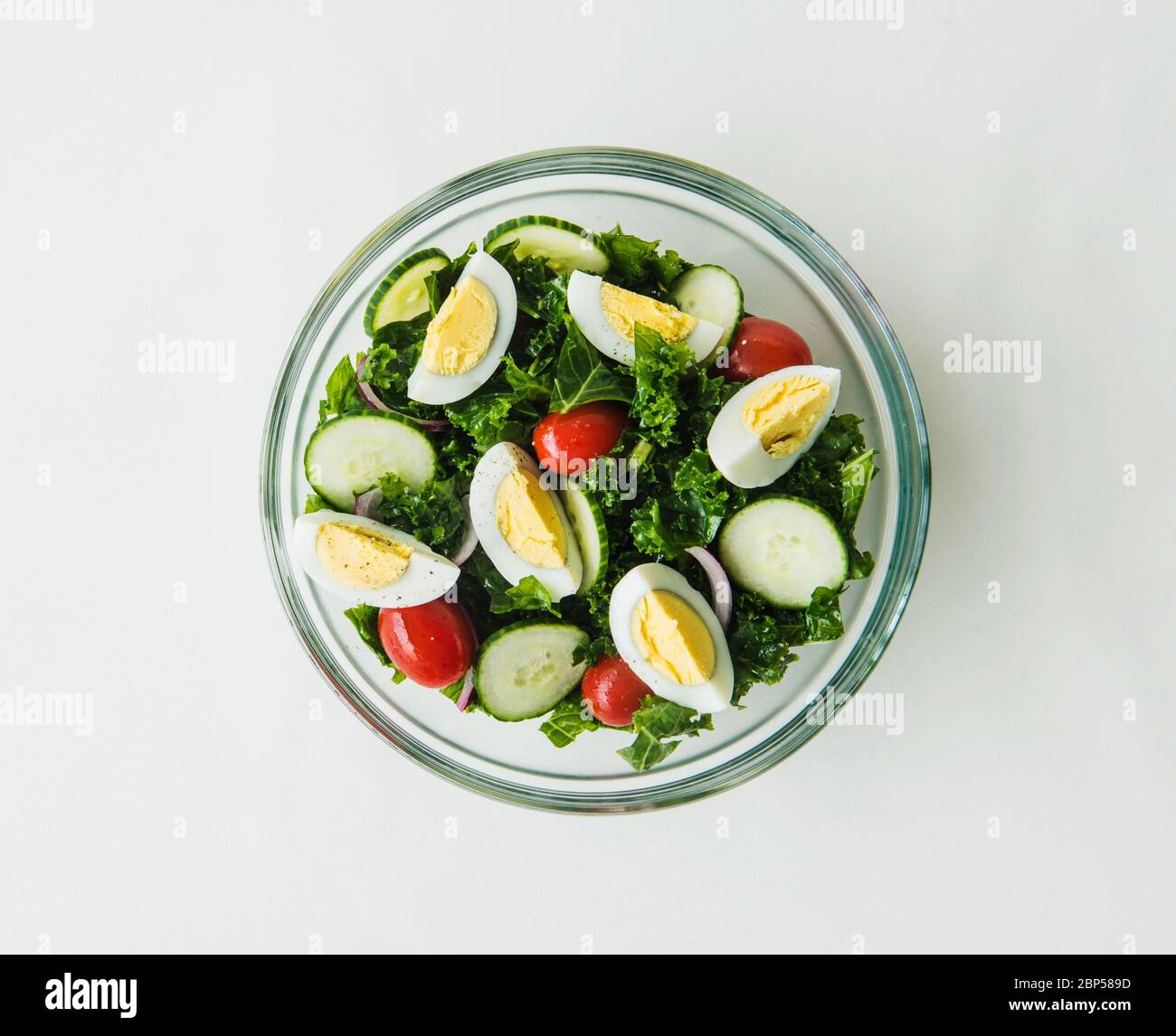 healthy kale salad with eggs, tomato, cucumber and avocado Stock Photo