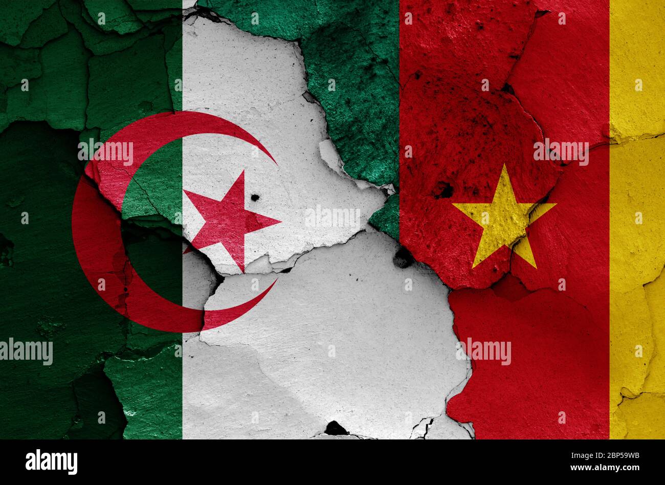 flags of Algeria and Cameroon painted on cracked wall Stock Photo