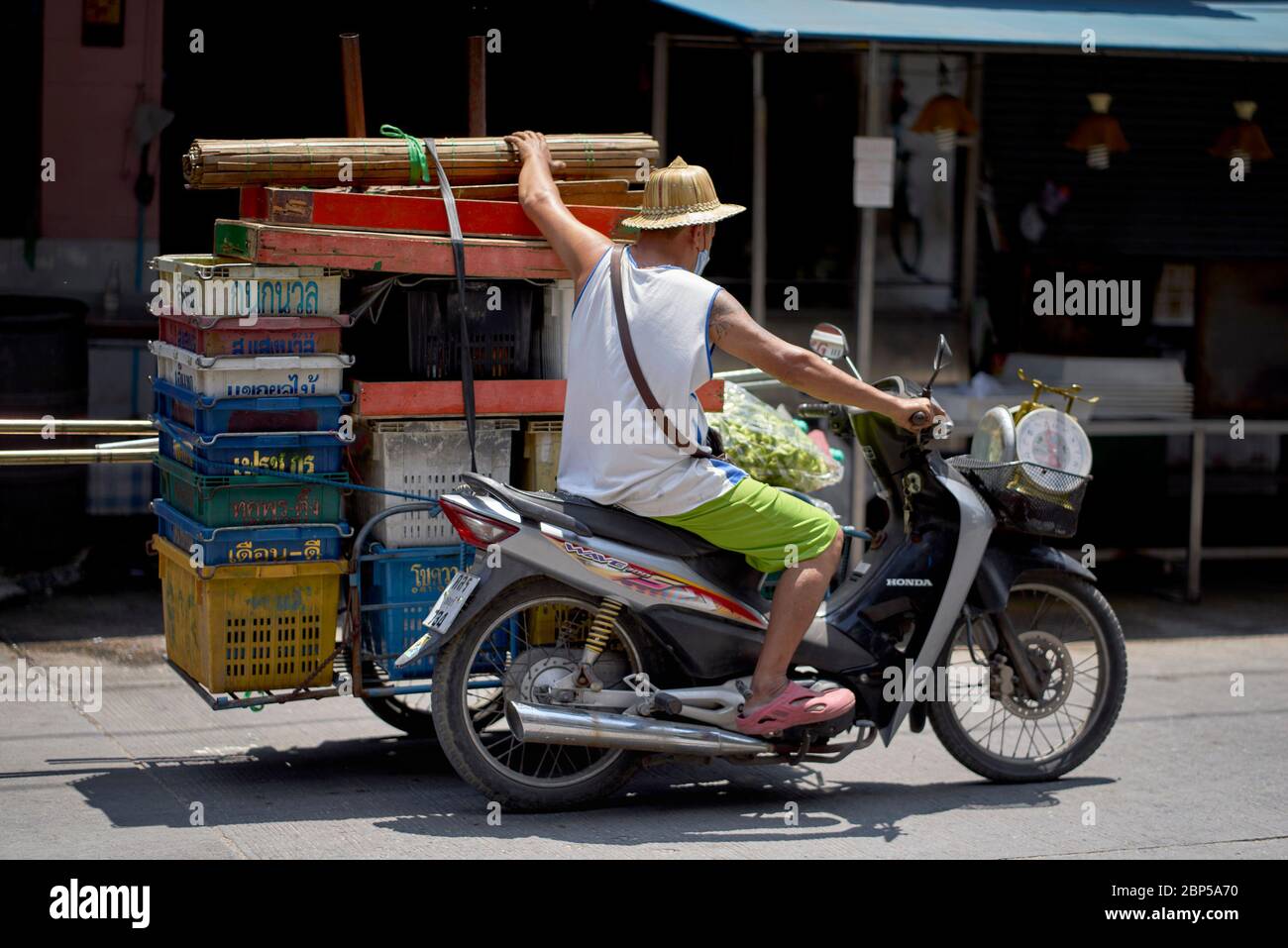 Thailand transport. Man riding a motorcycle sidecar rig on the way to his  site as a street market trader. Southeast Asia Stock Photo - Alamy