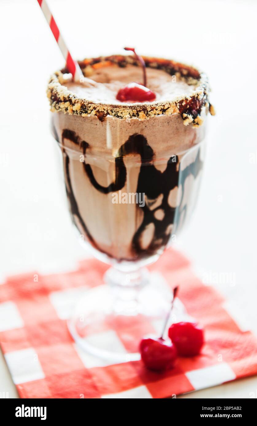 Chocolate milkshake with cherry and graham cracker garnish Stock Photo