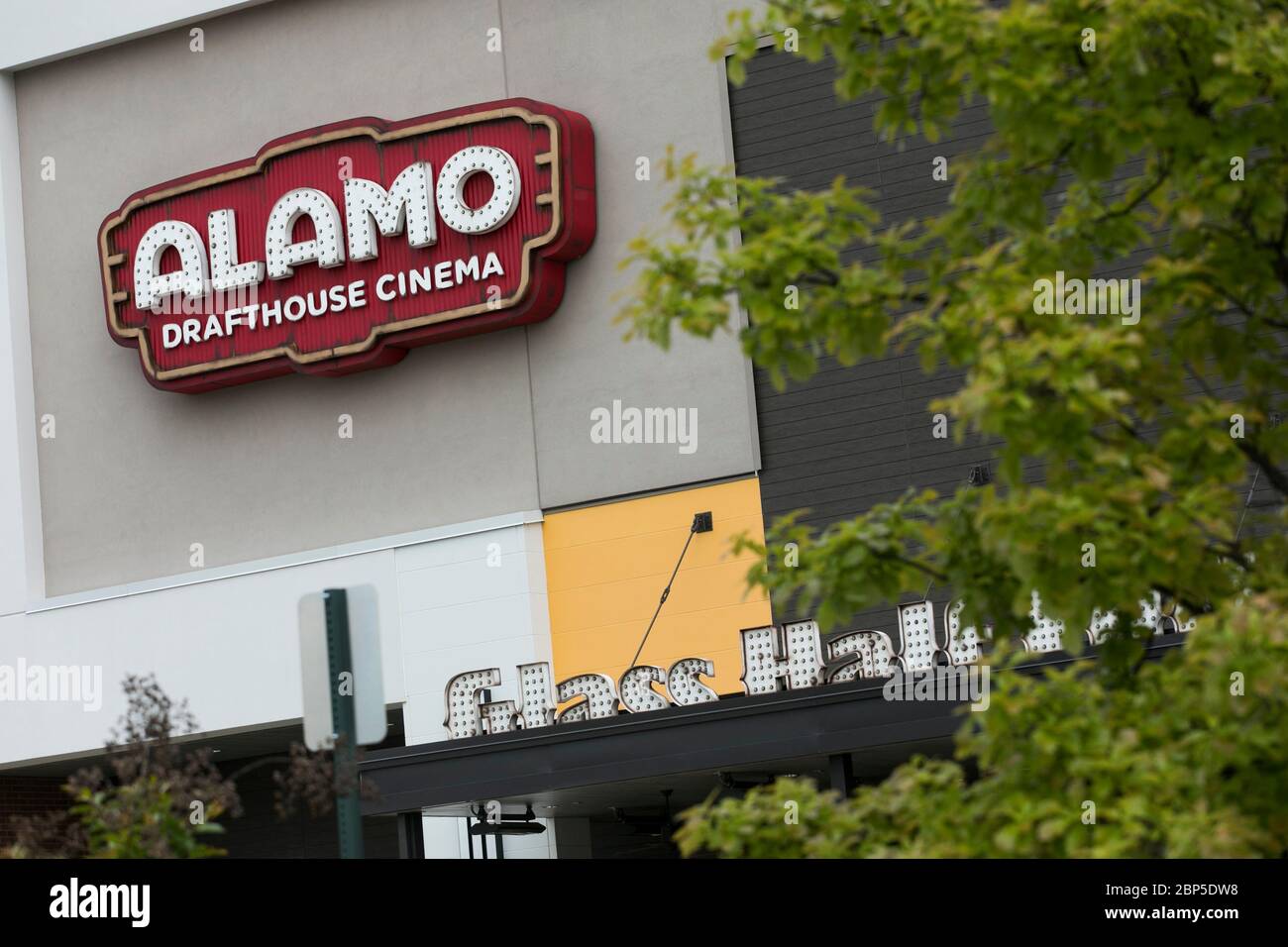 A logo sign outside of a The Alamo Drafthouse Cinema movie theater location in Charlottesville, Virginia on May 13, 2020. Stock Photo