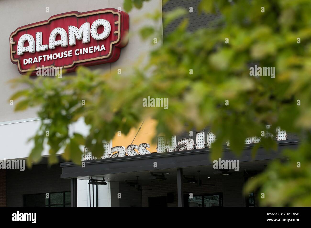 A logo sign outside of a The Alamo Drafthouse Cinema movie theater location in Charlottesville, Virginia on May 13, 2020. Stock Photo