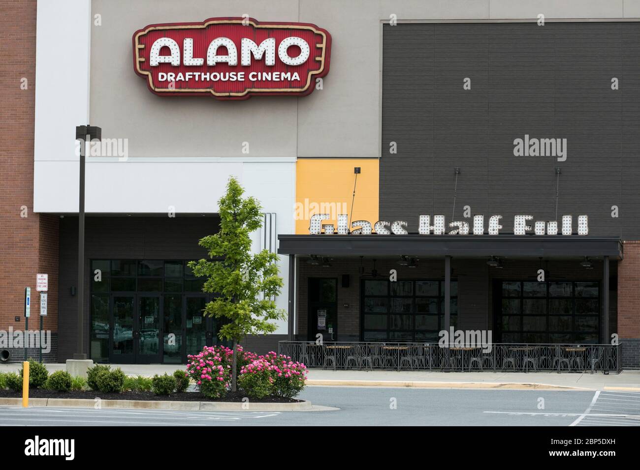 A logo sign outside of a The Alamo Drafthouse Cinema movie theater location in Charlottesville, Virginia on May 13, 2020. Stock Photo