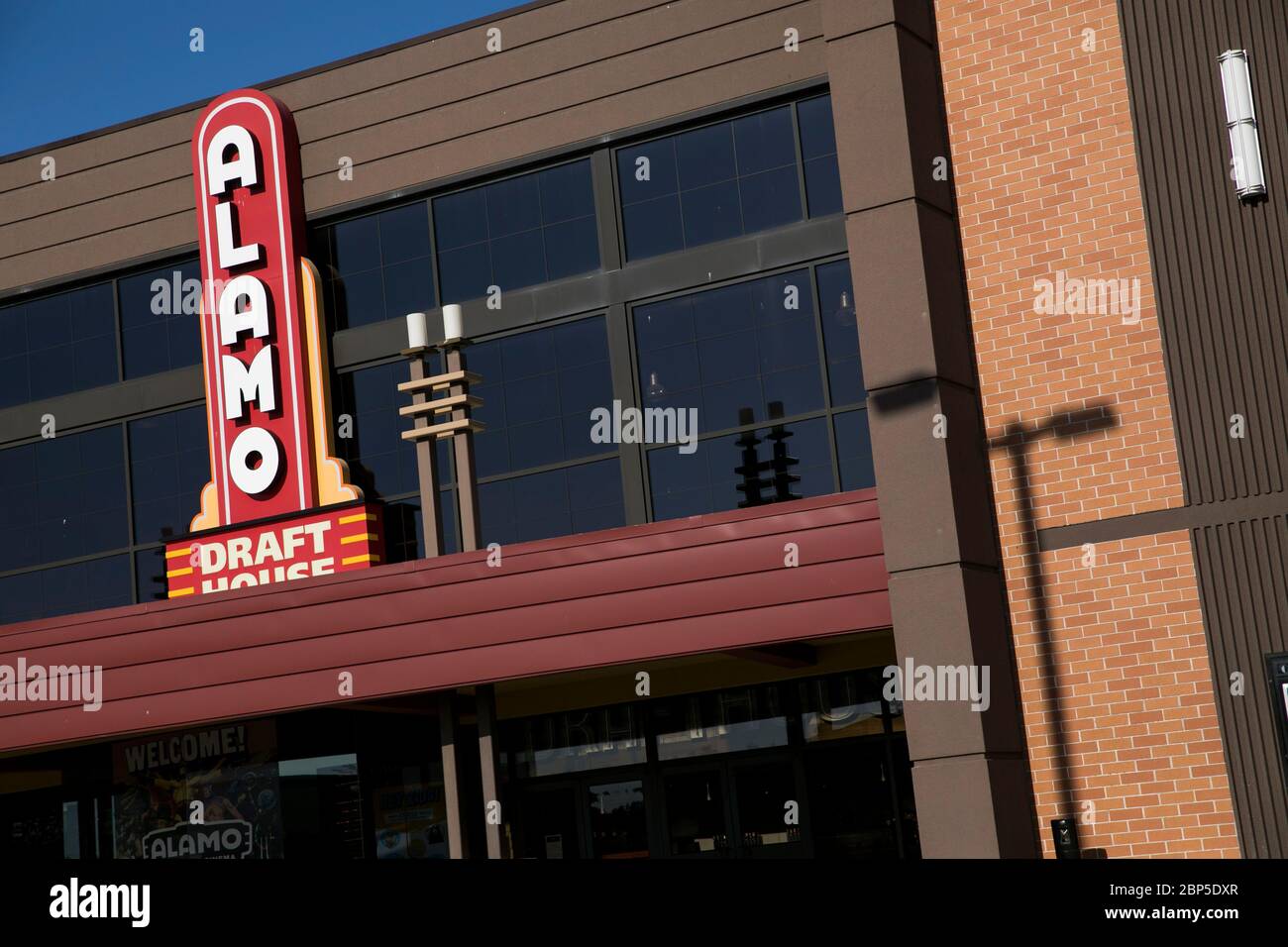 A logo sign outside of a The Alamo Drafthouse Cinema movie theater