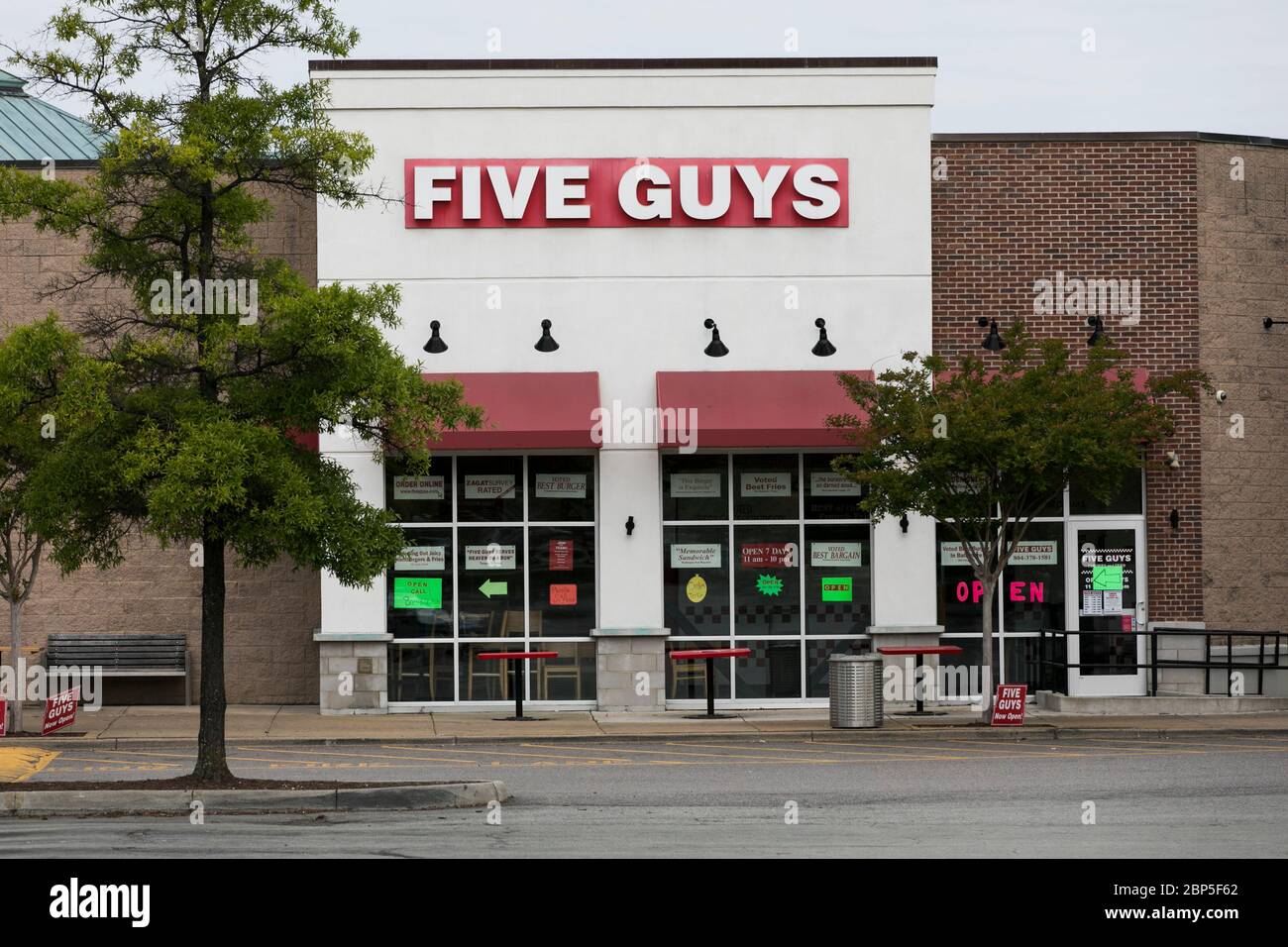 A logo sign outside of a Five Guys restaurant location in Richmond