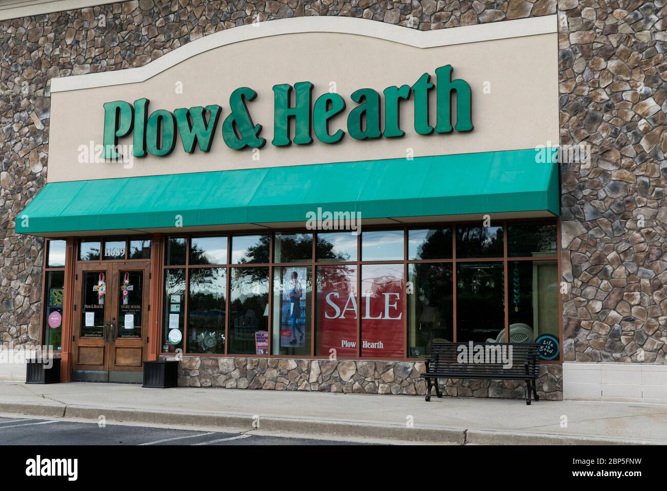 A logo sign outside of a Plow & Hearth retail store location in