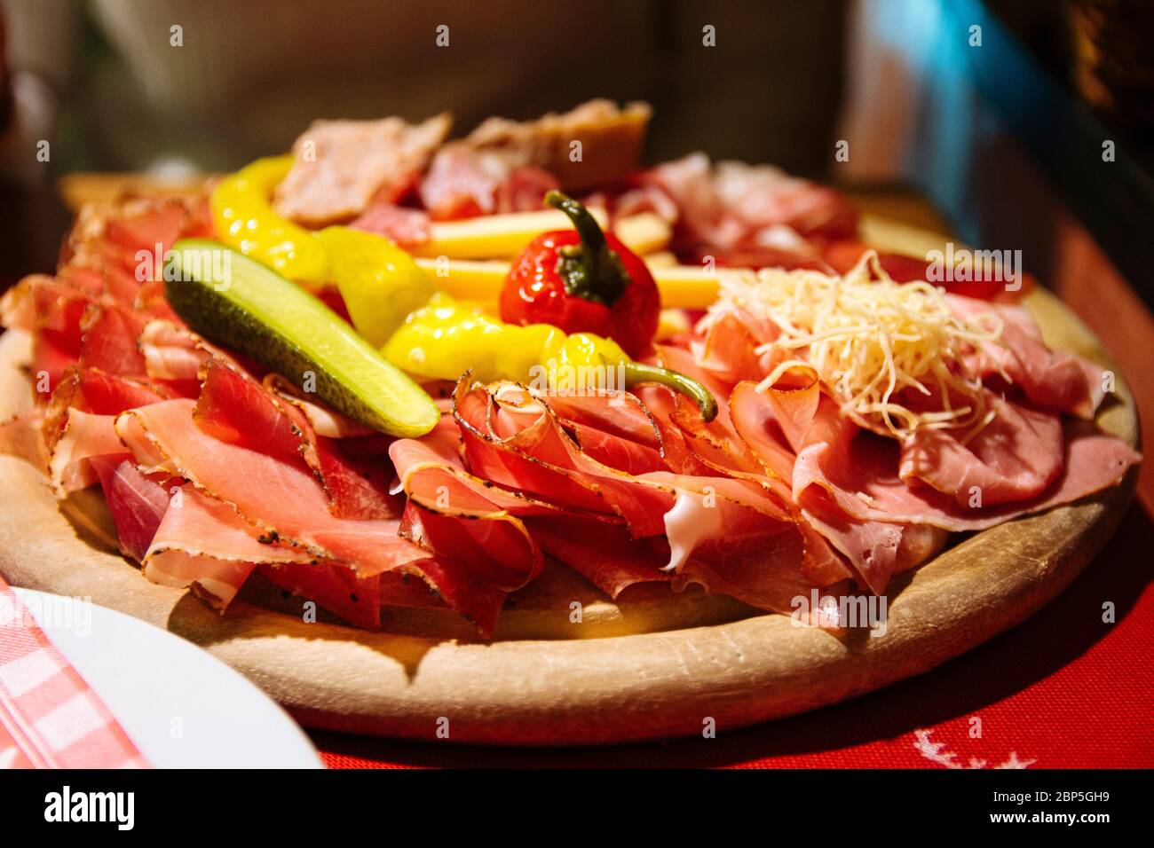 A typical tyrolean mixed cold platter served on a wooden board Stock Photo