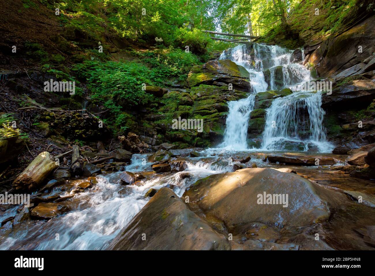 waterfall in the fores. rapid water of mountain river. beautiful nature background. calming summer landscape Stock Photo