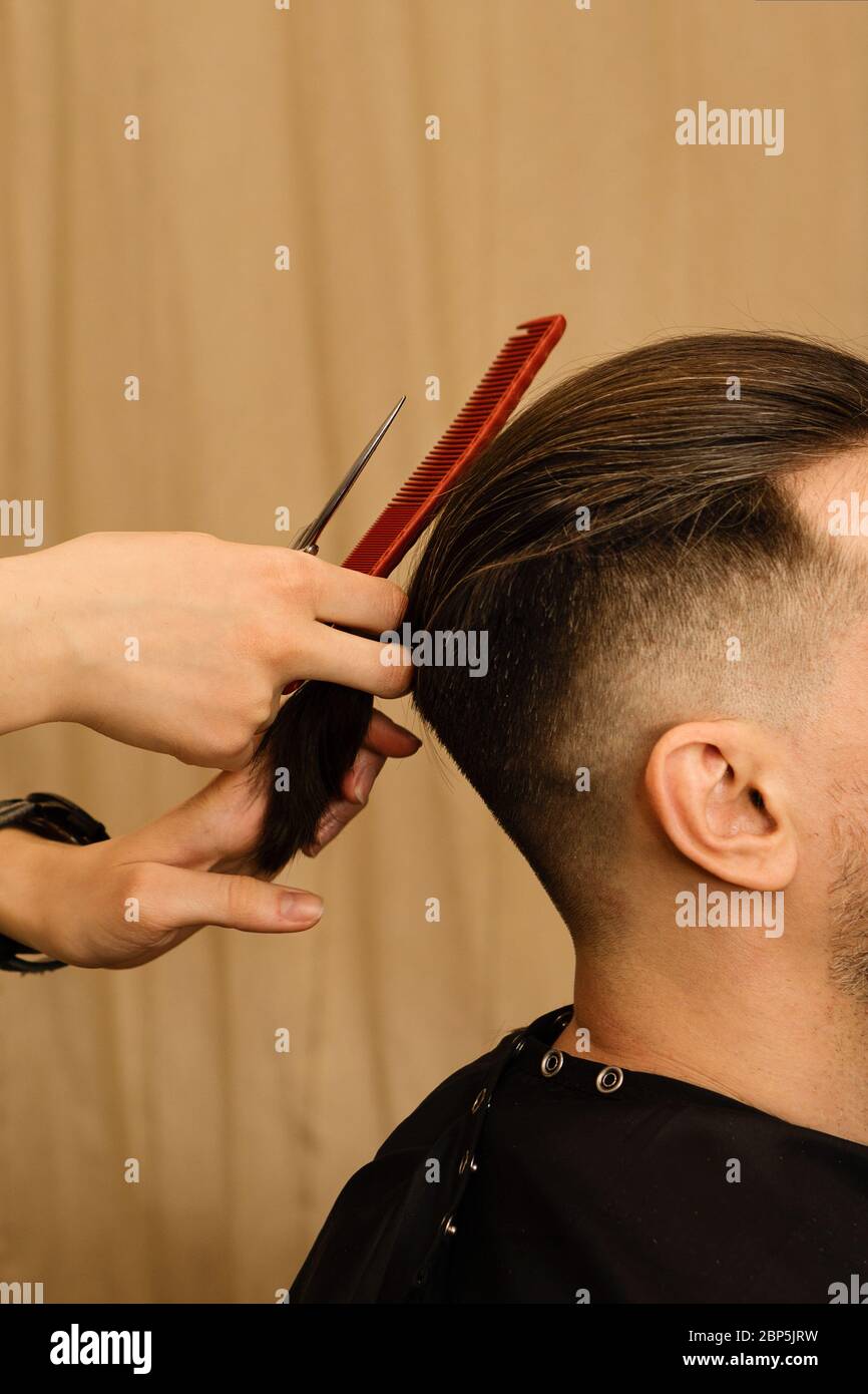 cutting male hair with scissors