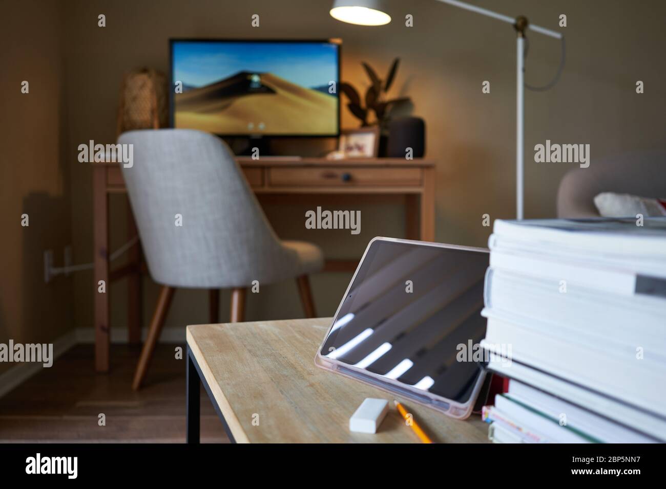 Tablet computer on the table with selective focus on the tablet camera. Online class and video conferencing at home. Stock Photo