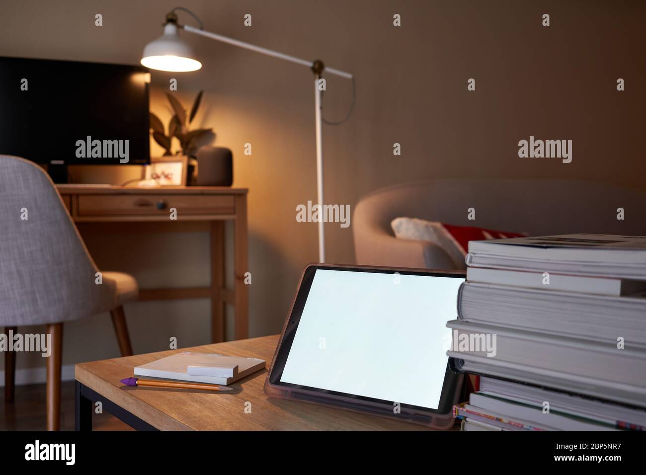 Tablet computer on the table with selective focus on the tablet camera. Online class and video conferencing at home. Stock Photo