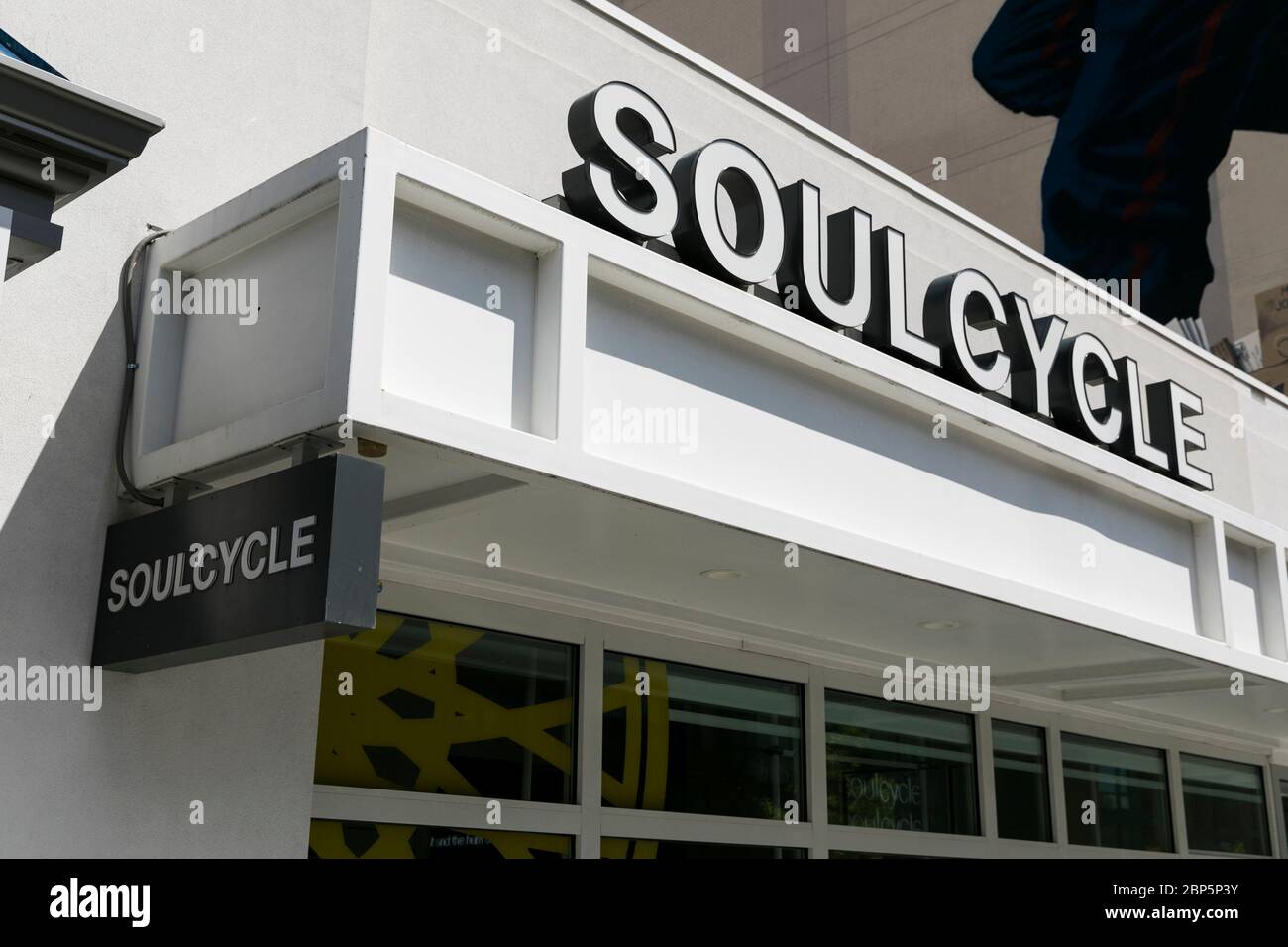 A logo sign outside of a SoulCycle location in Washington, D.C., on May 12, 2020. Stock Photo