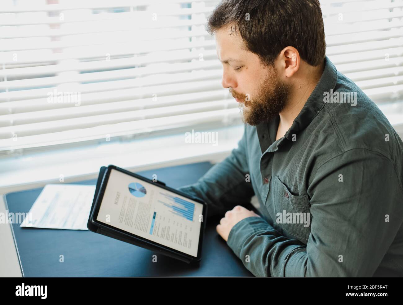 Engineer working with graphs and diagrams on tablet at office. Stock Photo