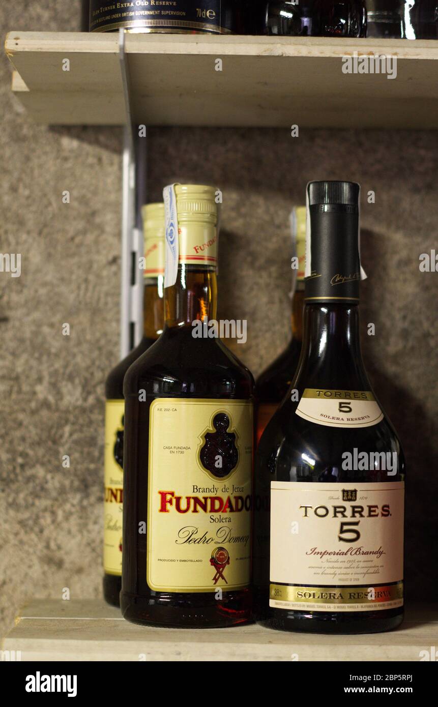 Unopened Spanish brandy bottles on a shelf Stock Photo