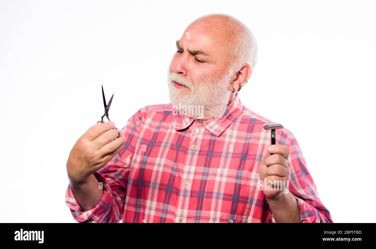 Mature man barber hold scissors and shaving blade on white background