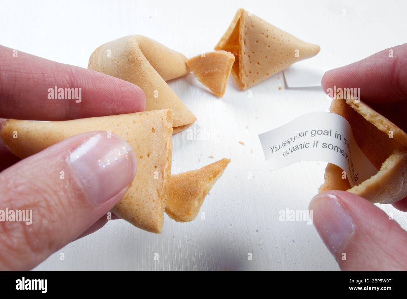 Fortune cookies in hands with advices, motivation mottos and blank space for copy Stock Photo