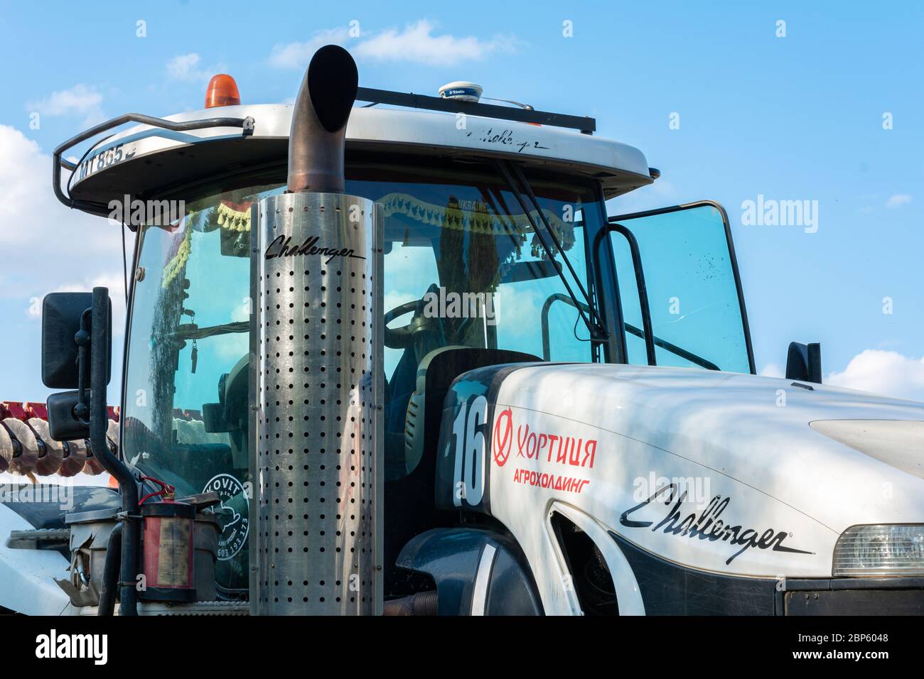 Catalytic converter tractor challenger and cab with large windows close up  on a background of blue sky. Exhaust pipe of a modern new   Stock Photo - Alamy