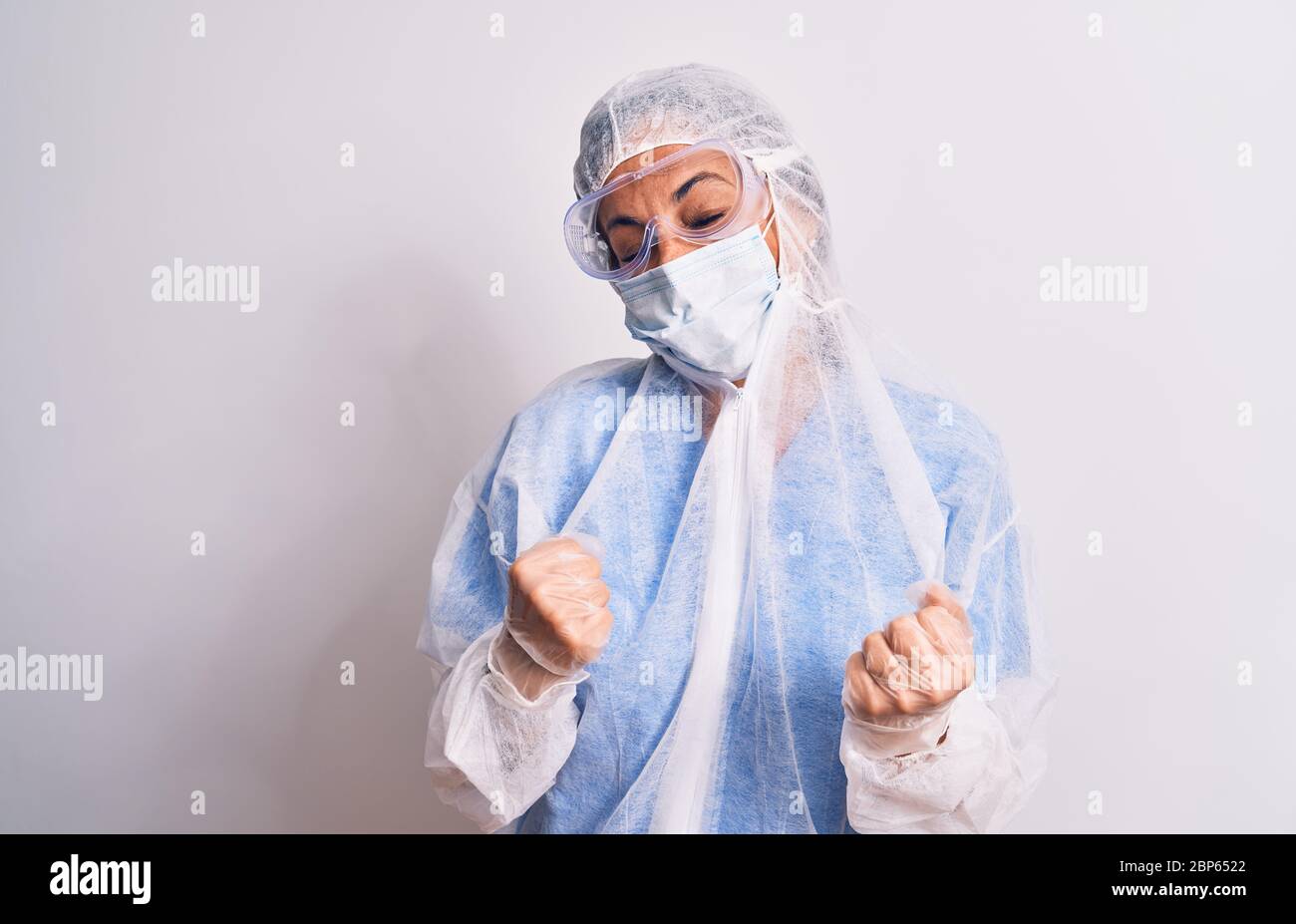 Middle age nurse woman wearing protection coronavirus equipment over ...