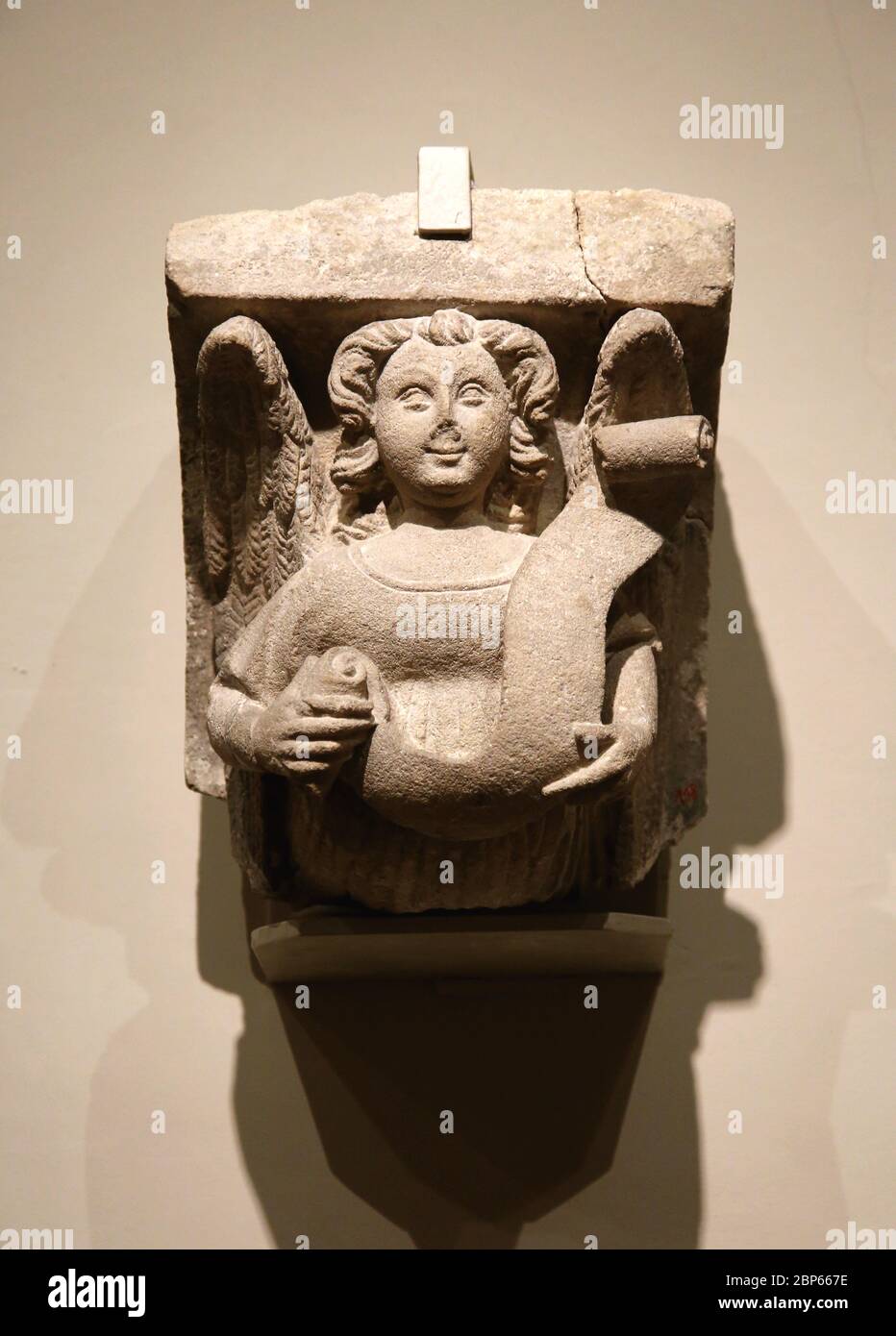 Carved corbel stone with angel 15 th century. Jordi de Deu ( c. 1363-1418) or workshop. Catalan Gothic art. Frederic Mares Museum, Barcelona. Stock Photo