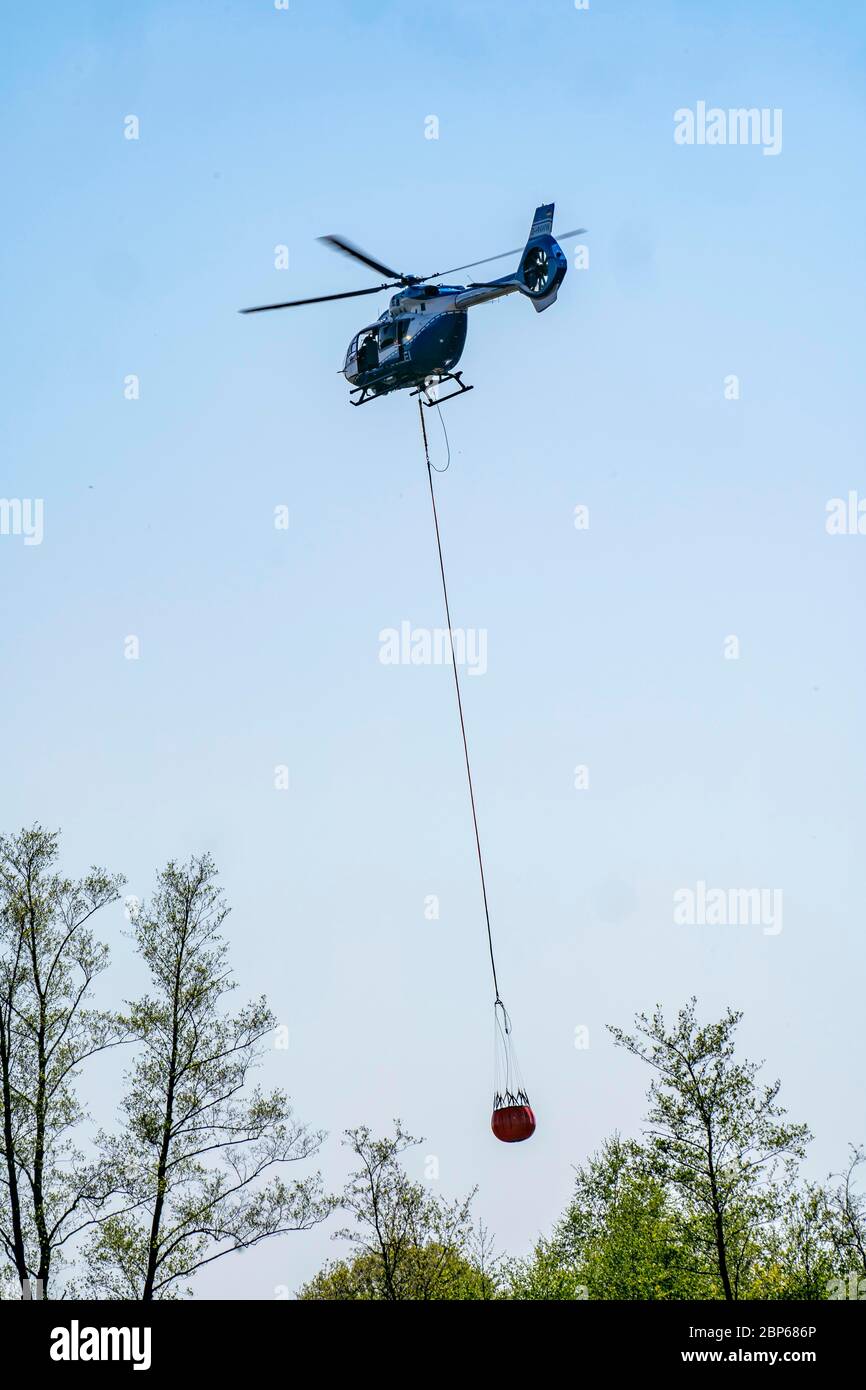 Forest fire in the German-Dutch border region near Niederkrüchten-Elmpt, in a nature reserve, deployment of fire-fighting helicopters, Airbus H145 , o Stock Photo