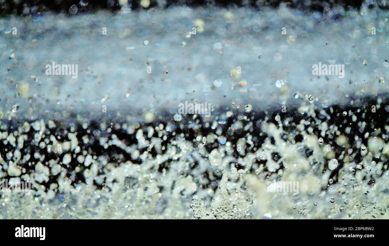 Water backgrounds with foam spray fast flow. The water in mad flows with droplets and whirlpools