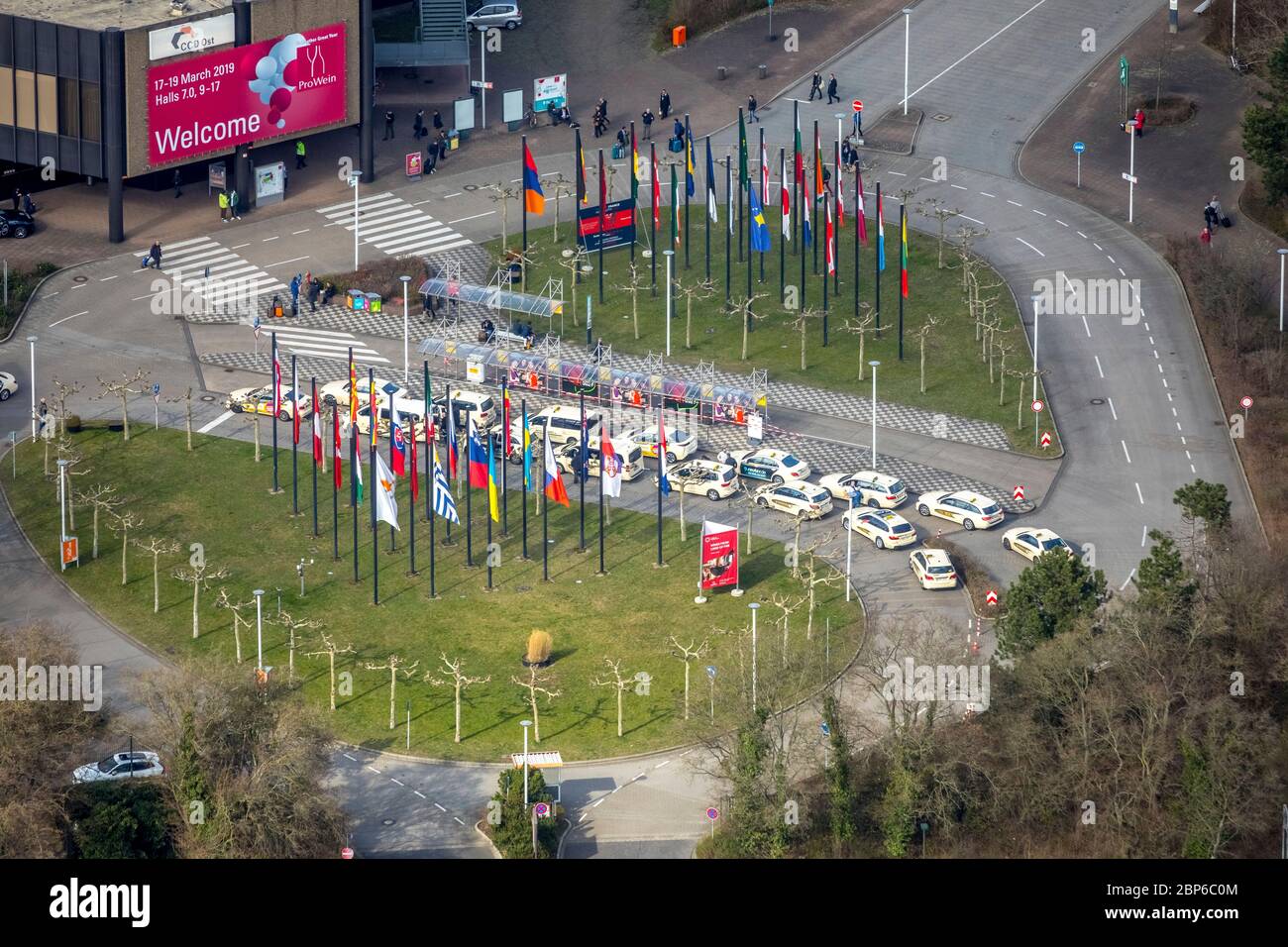 Aerial view, taxi rank, waiting taxis, taxis, flagpoles, flags, entrance to Messe Düsseldorf, Messe Düsseldorf am Rhein, new building, Düsseldorf, Rhineland, North Rhine-Westphalia, Germany Stock Photo