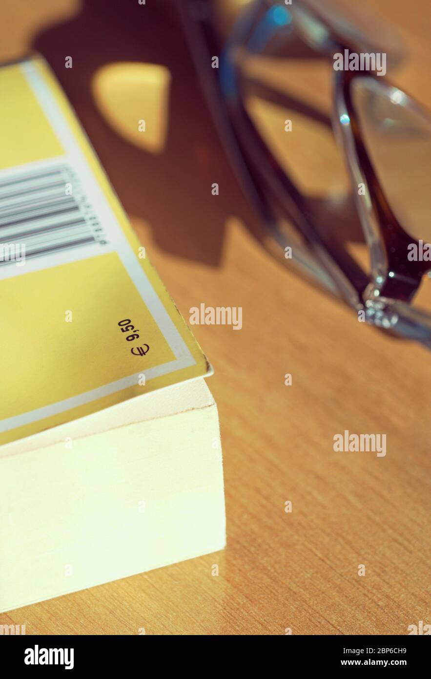 book and glasses on table Stock Photo