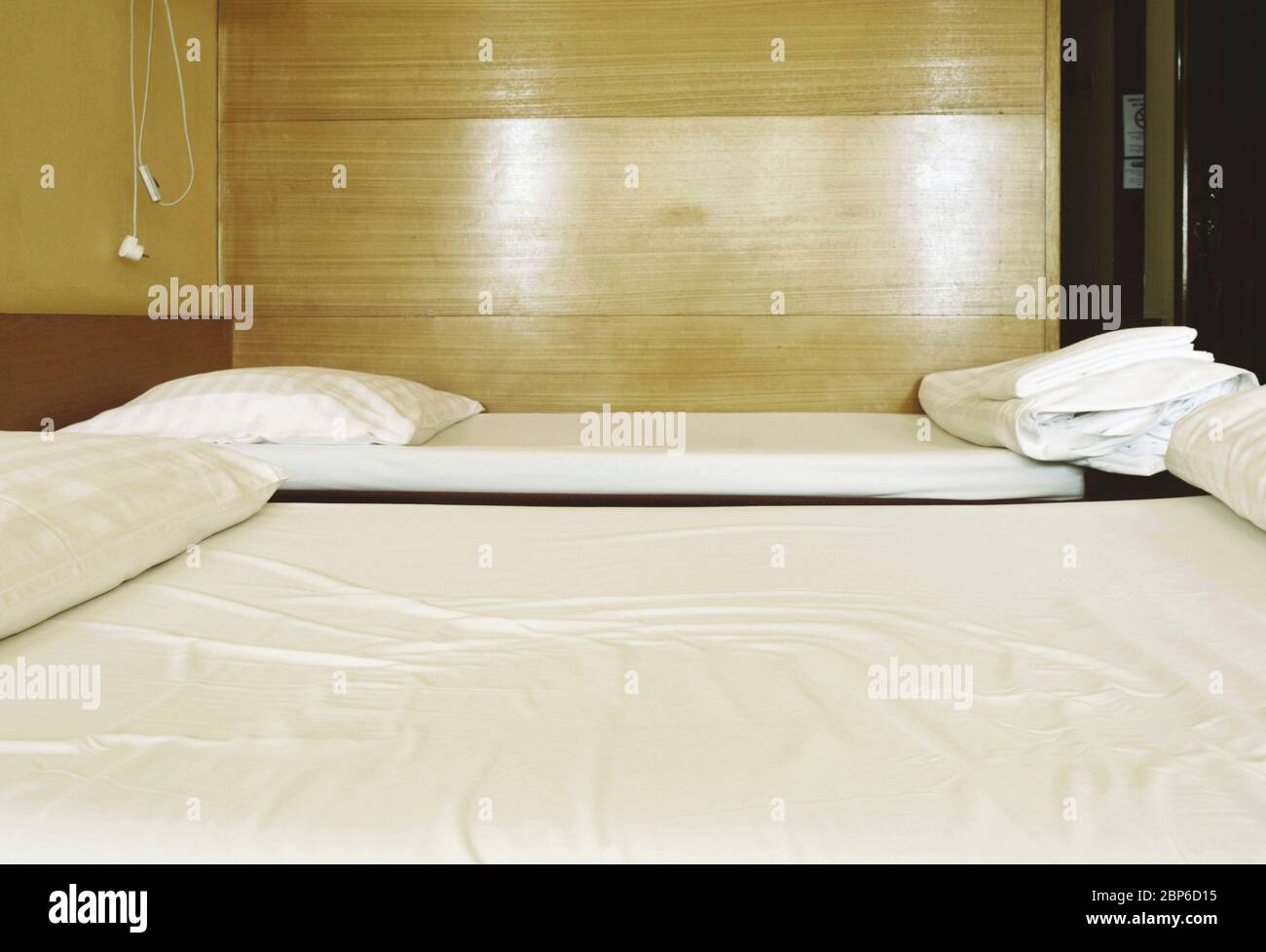two beds in a cheap hotel room Stock Photo