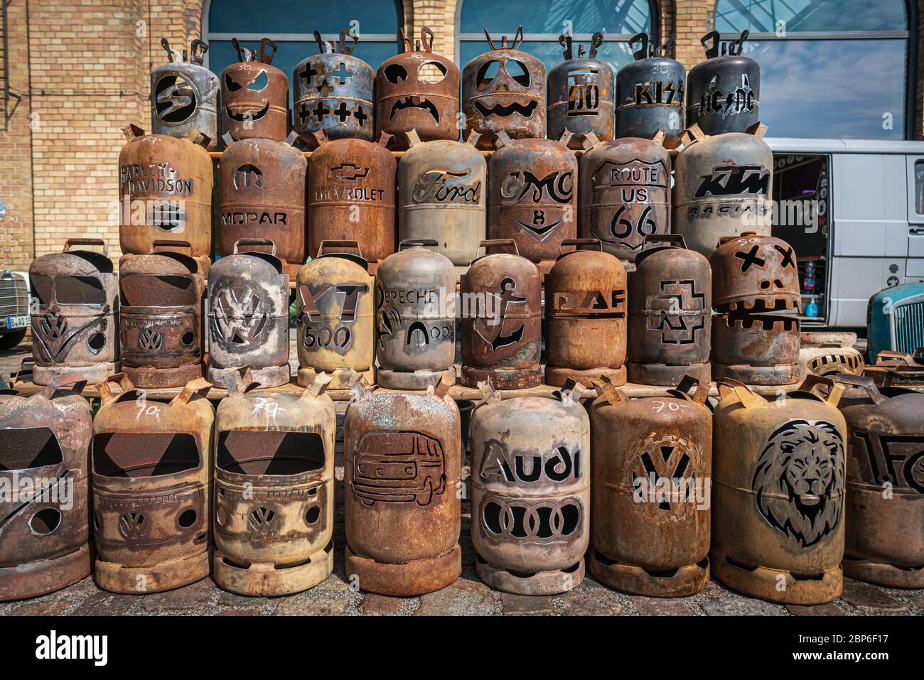 BERLIN - MAY 11, 2019: Sale in the flea market of old used gas cylinders with artistically beautiful patterns images on them. 32th Berlin-Brandenburg Oldtimer Day. Stock Photo
