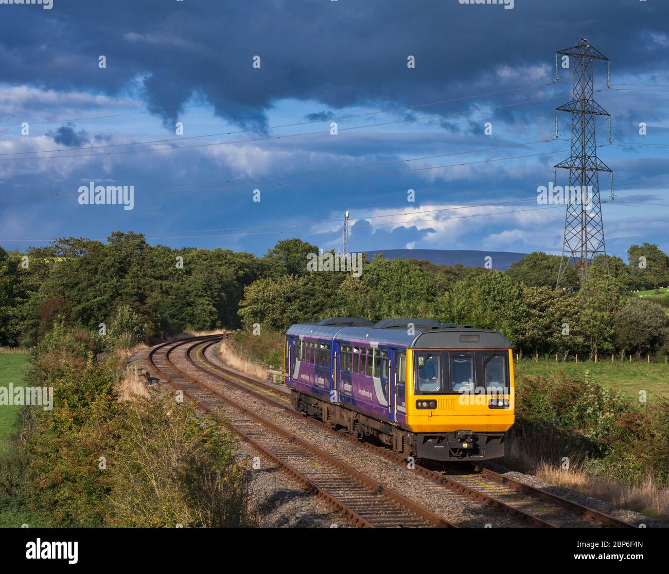 Northern rail class 142 pacer train 142093 on the scenic little north western railway line passing the countryside at Keerholme Stock Photo