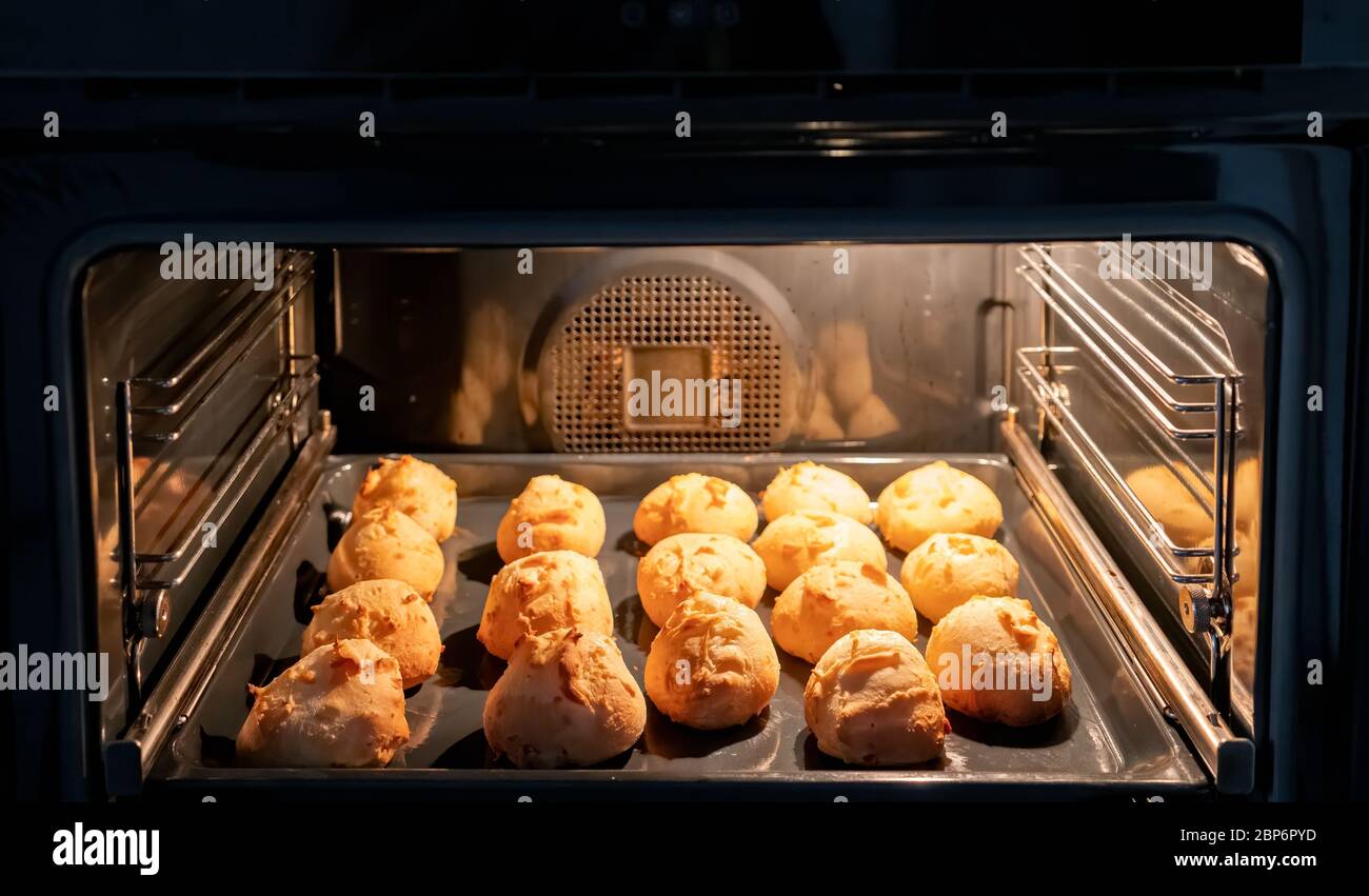 Preparing many cheese breads in home oven Stock Photo Alamy